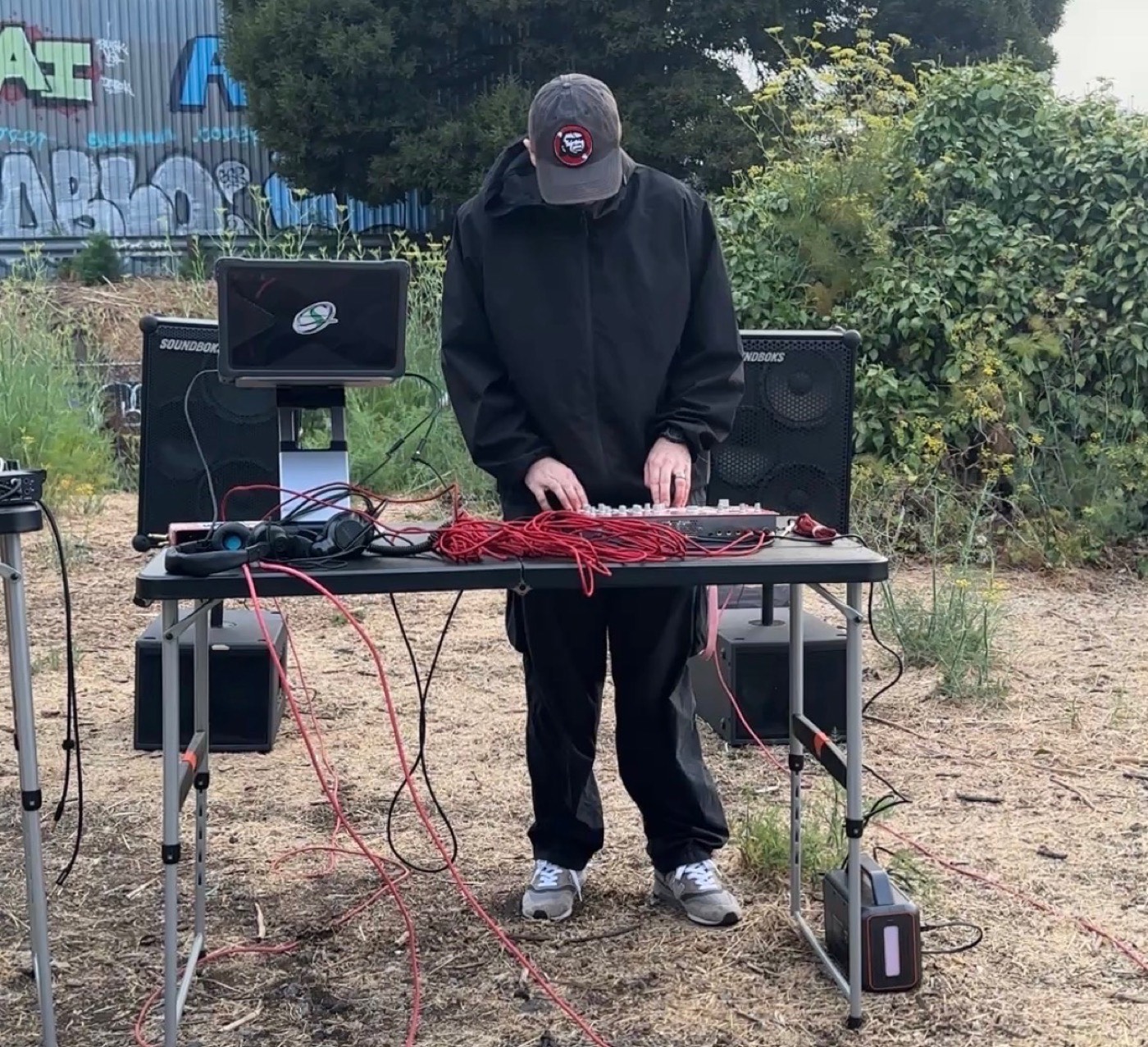 Battery-powered sound system set up outdoors on a grassy lot