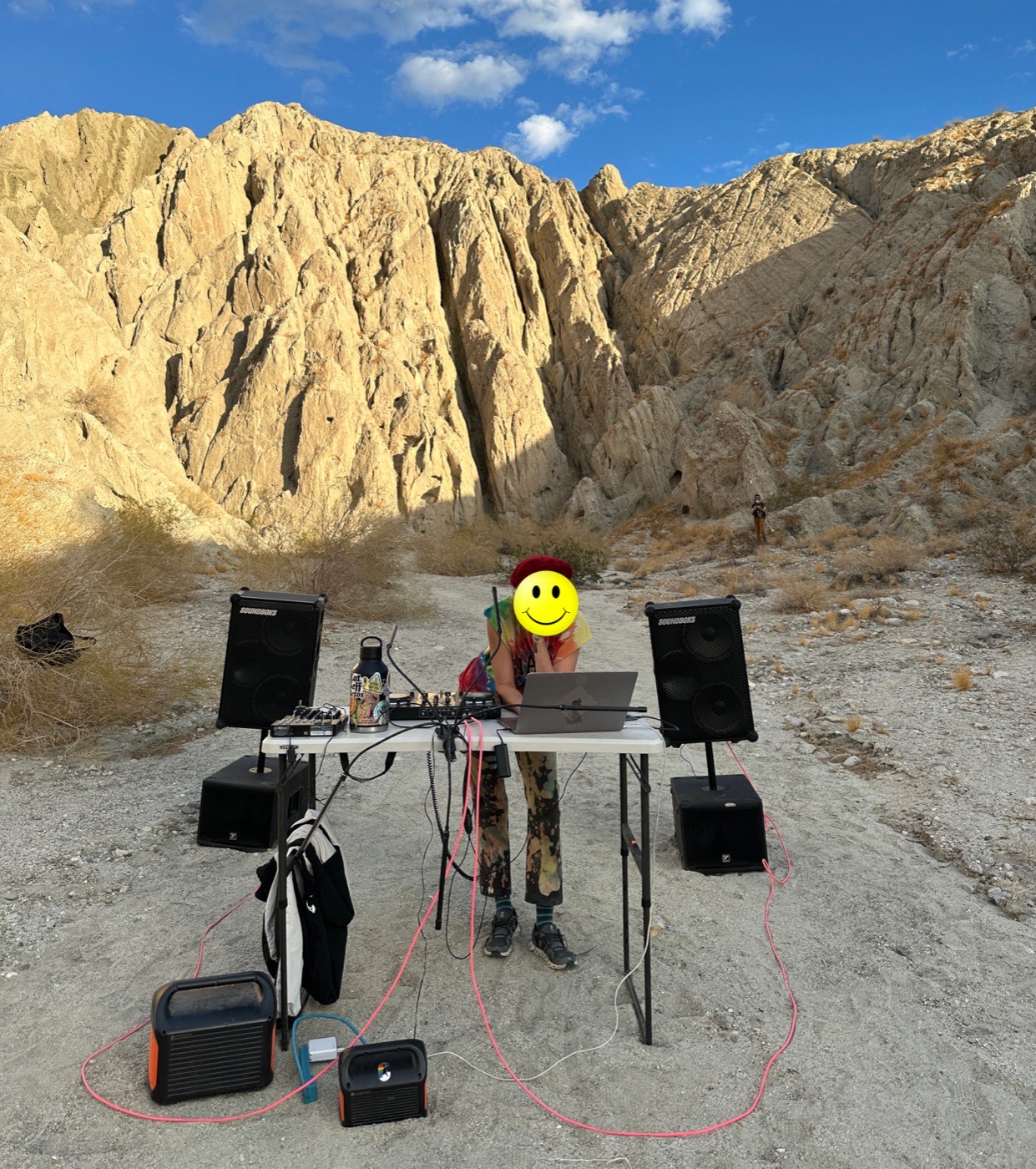 Battery-powered sound system set up in the desert with two subwoofers and two top speakers
